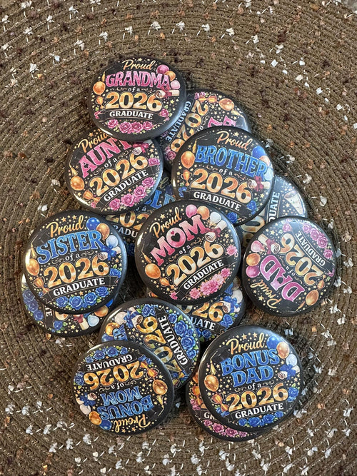 Celebrate your graduate in style with these vibrant 2.25" “Proud Family of a 2026 Graduate” button pins. Designed with bold colors, festive balloons, and floral accents, each pin highlights a special role—Mom, Dad, Grandma, Sister, Brother, Aunt, and more. Perfect for graduations, parties, and proud family moments, these lightweight pins with durable plastic backs are comfortable to wear and make a fun, meaningful keepsake.